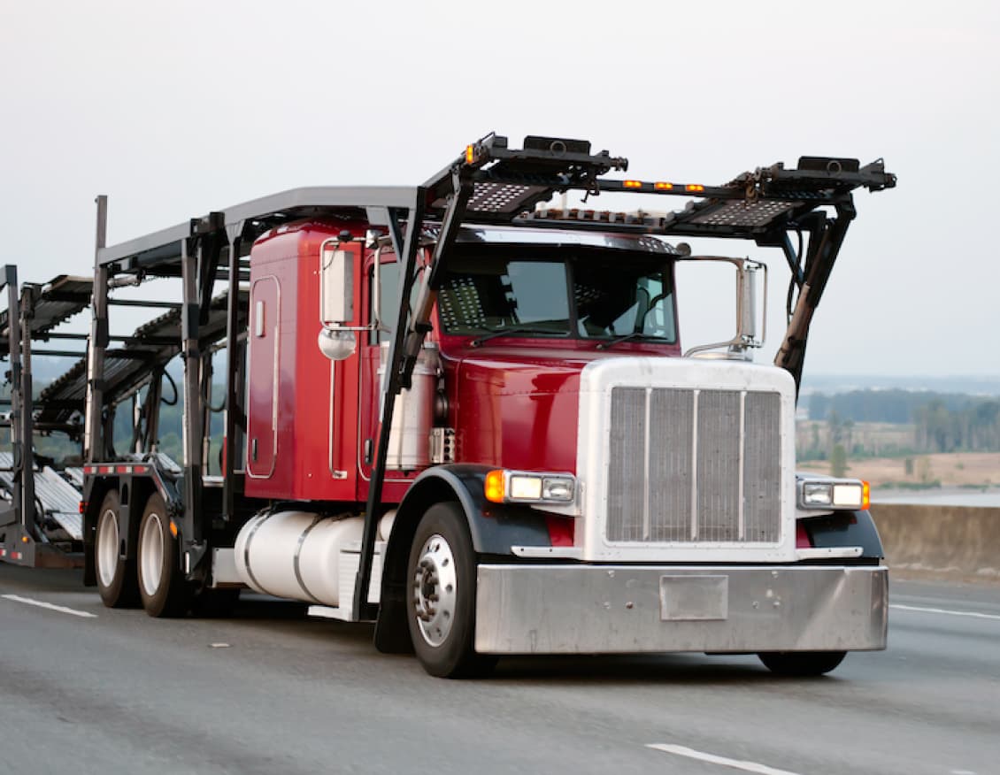A Sherpa auto transport carrier truck on the highway